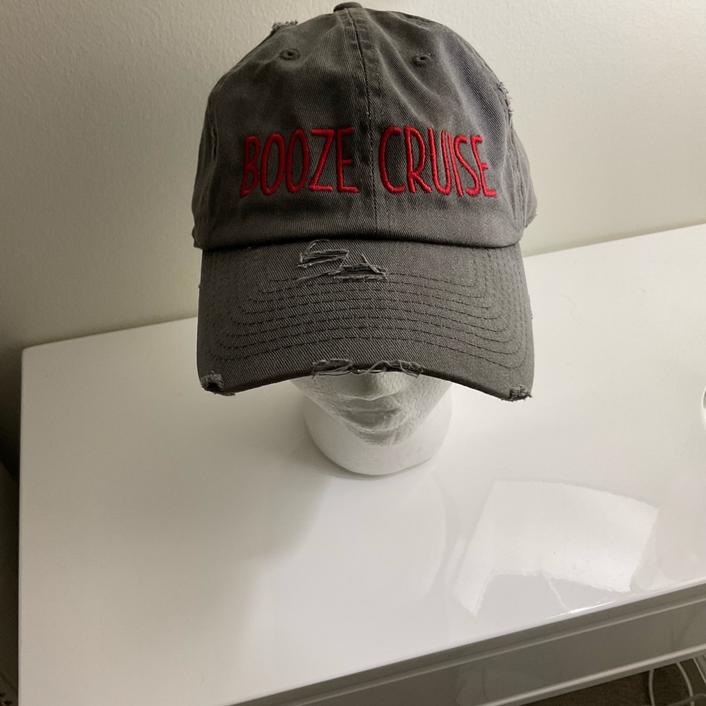 A distressed gray ball cap with Booze Cruise  embroidered in red. New